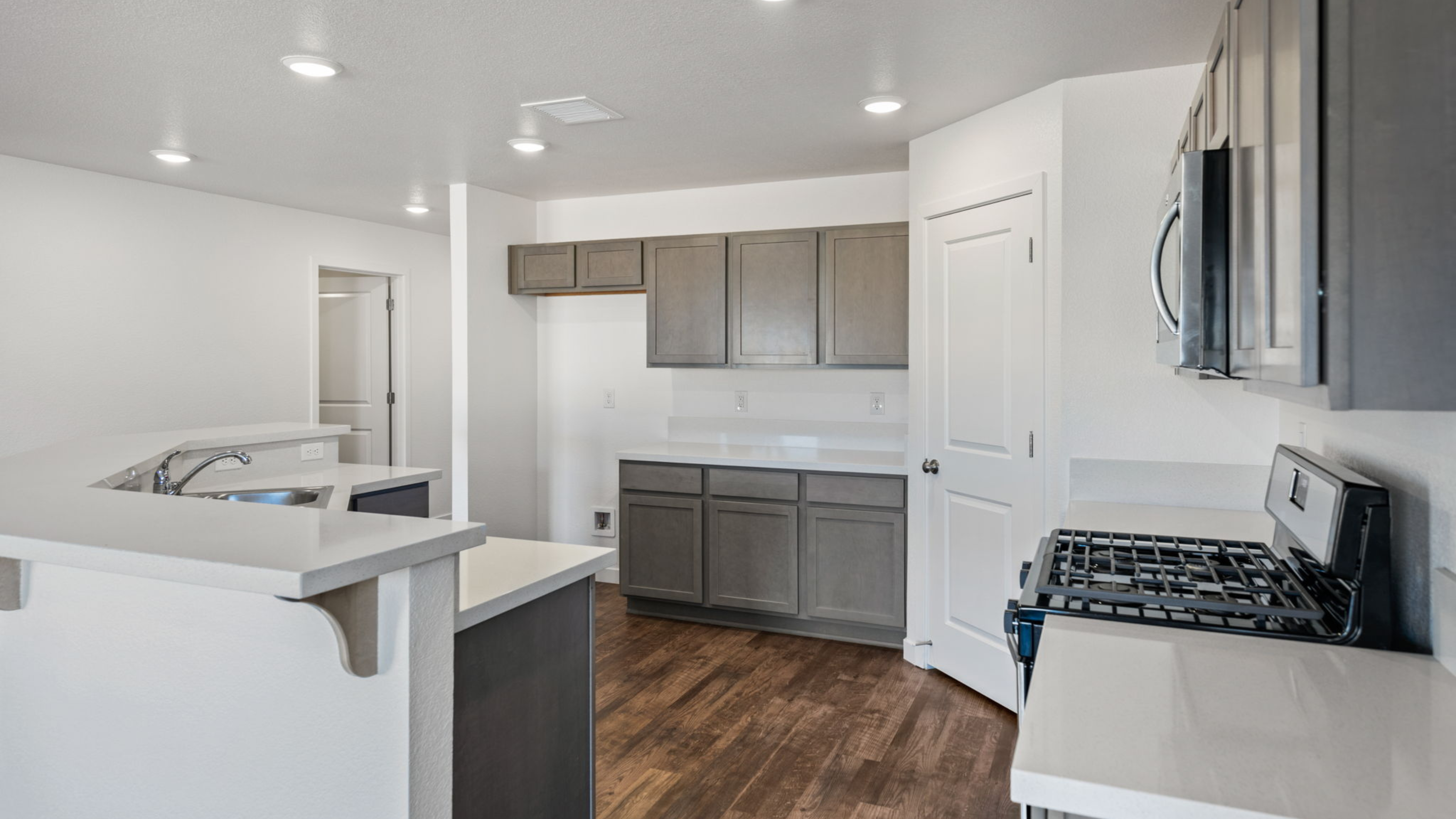 Spacious kitchen area in a GC Phase 5 townhome-style house, featuring ample cabinetry and natural light.